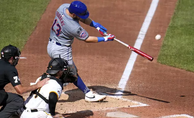 New York Mets' Luis Torrens (13) hits a double off Pittsburgh Pirates relief pitcher Dennis Santana, driving in three runs, during the third inning of a baseball game in Pittsburgh, Saturday, July 6, 2024. (AP Photo/Gene J. Puskar)