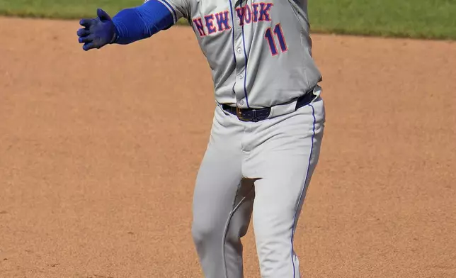 New York Mets' Jose Iglesias celebrates as he stands on second base after driving in a run with a double off Pittsburgh Pirates relief pitcher Ryder Ryan during the sixth inning of a baseball game in Pittsburgh, Saturday, July 6, 2024. (AP Photo/Gene J. Puskar)