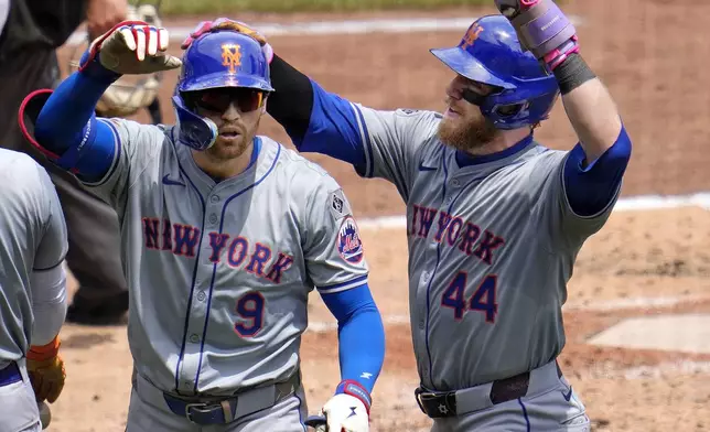 New York Mets' Brandon Nimmo (9) celebrates with Harrison Bader (44) after both scored on Nimmo's two-run home run off Pittsburgh Pirates starting pitcher Mitch Keller during the sixth inning of a baseball game in Pittsburgh, Monday, July 8, 2024. (AP Photo/Gene J. Puskar)