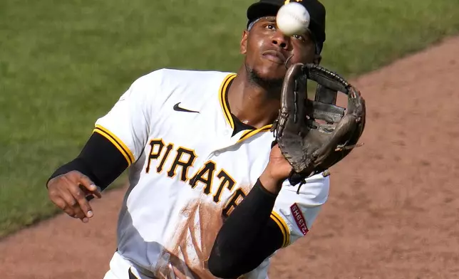 Pittsburgh Pirates third base Ke'Bryan Hayes catches a bunt attempted by New York Mets' Tyrone Taylor during the sixth inning of a baseball game in Pittsburgh, Saturday, July 6, 2024. (AP Photo/Gene J. Puskar)