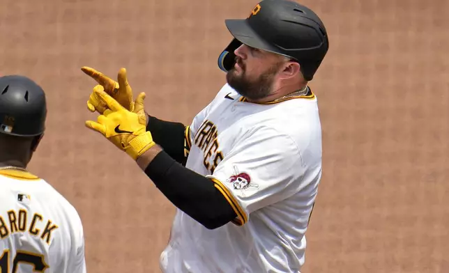 Pittsburgh Pirates' Rowdy Tellez, center, celebrates after driving in a run with a single off New York Mets relief pitcher Eric Orze during the sixth inning of a baseball game in Pittsburgh, Monday, July 8, 2024. (AP Photo/Gene J. Puskar)