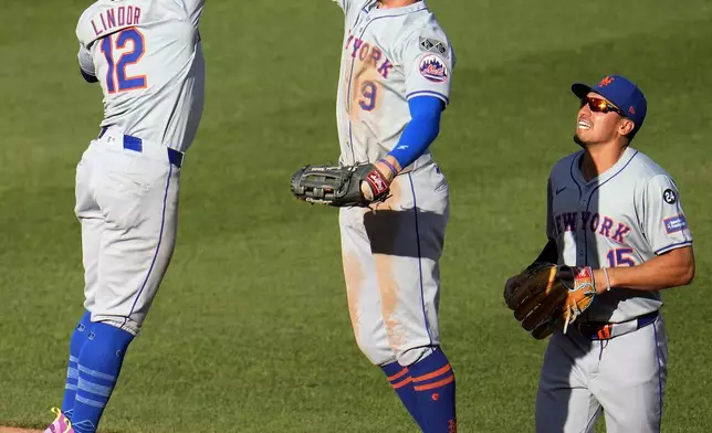 New York Mets' Francisco Lindor (12) and Brandon Nimmo (9) celebrate as Tyrone Taylor (15) watches after the final out of a baseball game against the Pittsburgh Pirates in Pittsburgh, Saturday, July 6, 2024. (AP Photo/Gene J. Puskar)