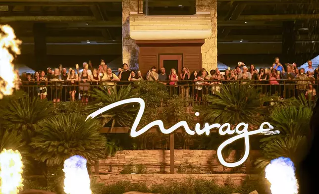 People watch the final scheduled volcano show during the final night of operations and gaming at The Mirage on Tuesday, July 16, 2024, in Las Vegas. (Chase Stevens/Las Vegas Review-Journal via AP)