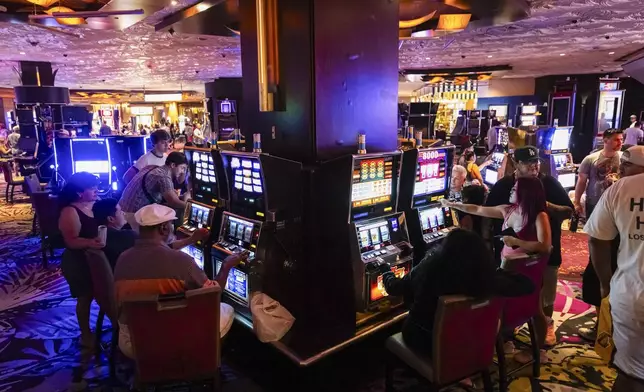 People play slot machines during the final night of operations and gaming at The Mirage on Tuesday, July 16, 2024, in Las Vegas. (Chase Stevens/Las Vegas Review-Journal via AP)