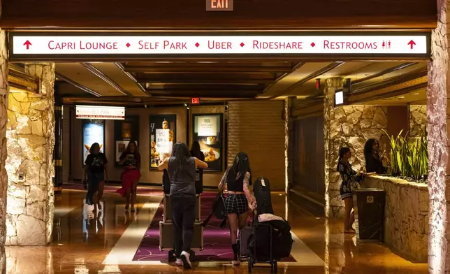 A pair of musicians make their way out during the final night of operations and gaming at The Mirage in the early hours of Wednesday, July 17, 2024, in Las Vegas. (Chase Stevens/Las Vegas Review-Journal via AP)