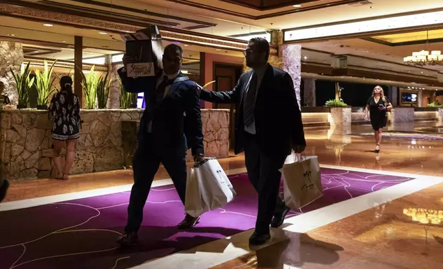 People make their way out during the final night of operations and gaming at The Mirage in the early hours of Wednesday, July 17, 2024, in Las Vegas. (Chase Stevens/Las Vegas Review-Journal via AP)