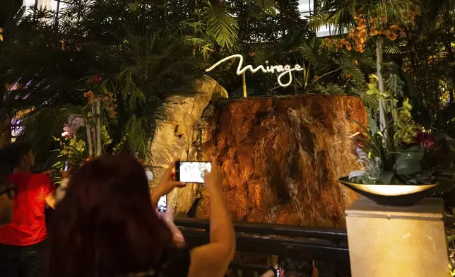 People take photos of the atrium during the final night of operations and gaming at The Mirage on Tuesday, July 16, 2024, in Las Vegas. (Chase Stevens/Las Vegas Review-Journal via AP)