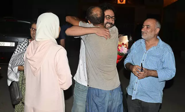 Omar Radi, a Journalist and activist is embraced by family member moment he was released from prison in Tifelt, Morocco, Monday, July. 29, 2024. Morocco's King Mohammed VI on Monday pardoned a group of journalists who were charged with sex crimes and espionage in prosecutions widely condemned by press freedom advocates as retaliatory in response to critical reporting. (AP Photo)