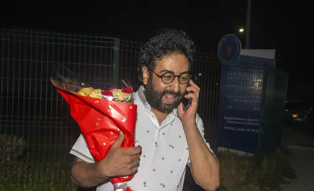 Omar Radi, a journalist and activist, speaks on the phone after he was pardoned and released from prison in Tifelt, Morocco, Monday, July 29, 2024. Morocco's King Mohammed VI on Monday pardoned a group of journalists who were charged with sex crimes and espionage in prosecutions widely condemned by press freedom advocates as retaliatory in response to critical reporting. (AP Photo)