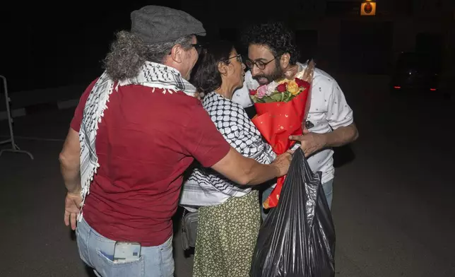 Omar Radi, a journalist and activist, right, is embraced by family members after he was released from prison in Tifelt, Morocco, Monday, July 29, 2024. Morocco's King Mohammed VI on Monday pardoned a group of journalists who were charged with sex crimes and espionage in prosecutions widely condemned by press freedom advocates as retaliatory in response to critical reporting. (AP Photo)