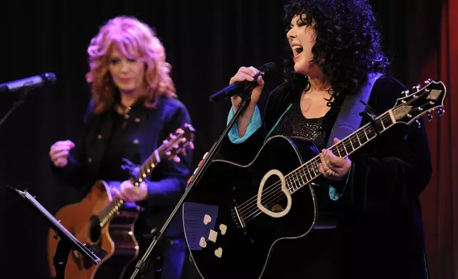 FILE - Nancy Wilson, left, and her sister Ann, of the band Heart, perform during "An Evening with Heart" at the Grammy Museum in Los Angeles on May 24, 2010. Ann Wilson says she has cancer. The band is postponing the remaining shows on its Royal Flush Tour. (AP Photo/Chris Pizzello, File)