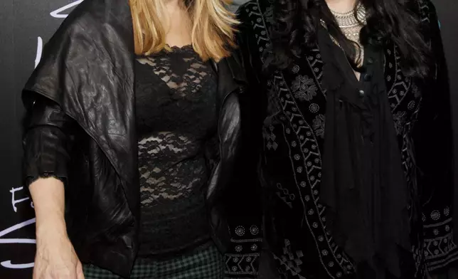 FILE - Nancy Wilson, left, and Ann Wilson, of the band Heart, attend the premiere of HBO's "Foo Fighters Sonic Highway" on Oct. 14, 2014, In New York. Ann Wilson says she has cancer. The band is postponing the remaining shows on its Royal Flush Tour. (Photo by Andy Kropa/Invision/AP, File)