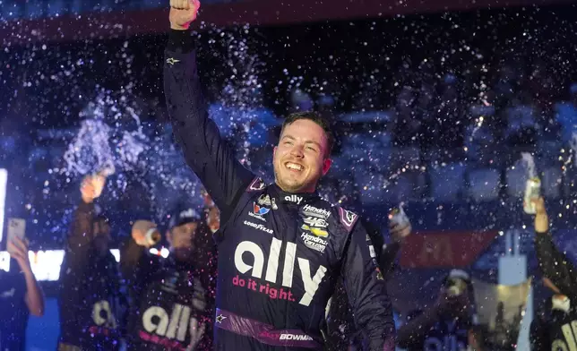 Alex Bowman is sprayed by teammates after winning a NASCAR Cup Series auto race, Sunday, July 7, 2024, in Chicago. (AP Photo/Erin Hooley)