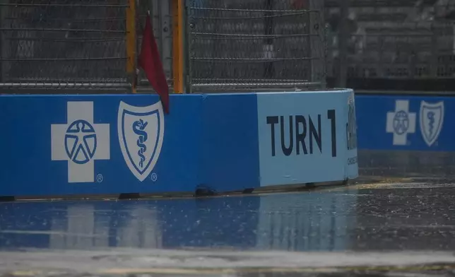 A red flag signals race stoppage as rain pours down during a NASCAR Cup Series auto race, Sunday, July 7, 2024, in Chicago. (AP Photo/Erin Hooley)