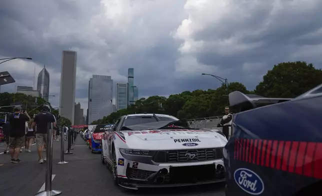 Cars are lined up along Pit Row before a NASCAR Cup Series auto race, Sunday, July 7, 2024, in Chicago. (AP Photo/Erin Hooley)