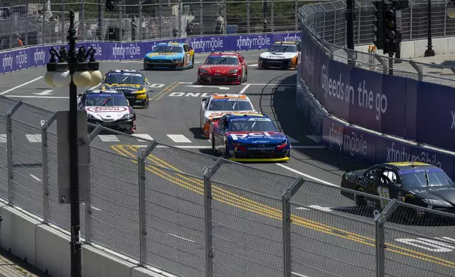 Cars navigate turn 19 during a NASCAR Xfinity Series street course auto race in Grant Park, Saturday, July 6, 202 4 in Chicago. (Tyler Pasciak LaRiviere/Chicago Sun-Times via AP)