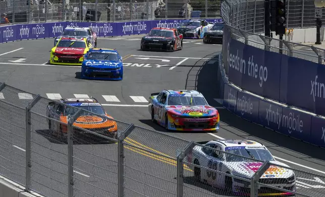 Drivers navigate Turn 19 during a NASCAR Xfinity Series street course auto race in Grant Park in Chicago, Saturday, July 6, 2024. (Tyler Pasciak LaRiviere/Chicago Sun-Times via AP)