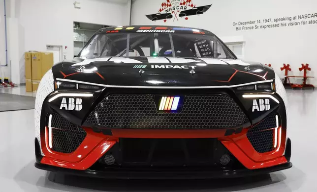 A prototype of the first electric racecar is displayed at the NASCAR R&amp;D Center in Concord, N.C., Monday, July 1, 2024. The top motorsports series in North America partnered with Chevrolet, Ford, Toyota and electrification company ABB to demonstrate a high-performance electric vehicle and gauge fan interest in electric racing. (AP Photo/Nell Redmond)