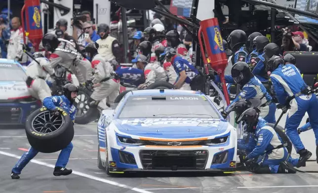 Kyle Larson makes a pit stop during a NASCAR Cup Series auto race at Indianapolis Motor Speedway, Sunday, July 21, 2024, in Indianapolis. (AP Photo/Darron Cummings)