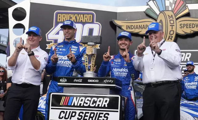 From left to right, Jeff Gordon, Cliff Daniels, Kyle Larson and Rick Hendrick celebrate after Larson won a NASCAR Cup Series auto race at Indianapolis Motor Speedway, Sunday, July 21, 2024, in Indianapolis. (AP Photo/Darron Cummings)