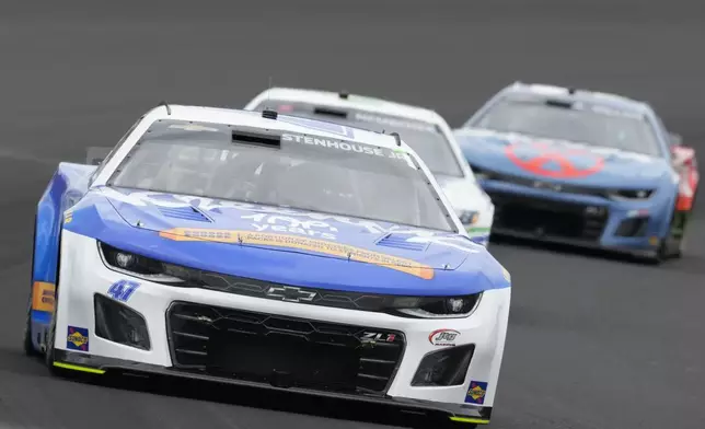 Ricky Stenhouse Jr. drives out of a turn during a NASCAR Cup Series auto race at Indianapolis Motor Speedway, Sunday, July 21, 2024, in Indianapolis. (AP Photo/Darron Cummings)