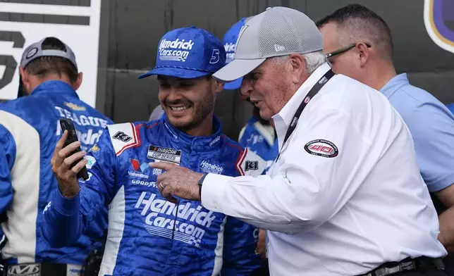 Kyle Larson, front left, walks with Rick Hendric, front right, after Larson won a NASCAR Cup Series auto race at Indianapolis Motor Speedway, Sunday, July 21, 2024, in Indianapolis. (AP Photo/Darron Cummings)