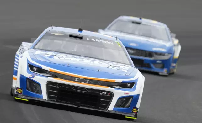 Kyle Larson drives out of a turn during a NASCAR Cup Series auto race at Indianapolis Motor Speedway, Sunday, July 21, 2024, in Indianapolis. (AP Photo/Darron Cummings)