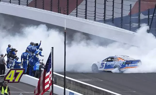 Kyle Larson celebrates after winning a NASCAR Cup Series auto race at Indianapolis Motor Speedway, Sunday, July 21, 2024, in Indianapolis. (AP Photo/Darron Cummings)