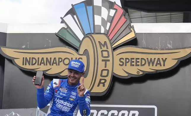 Kyle Larson celebrates after winning a NASCAR Cup Series auto race at Indianapolis Motor Speedway, Sunday, July 21, 2024, in Indianapolis. (AP Photo/Darron Cummings)