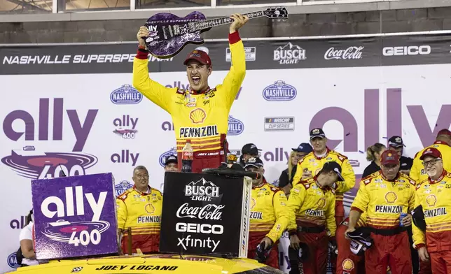 Joey Logano, top, celebrates after winning a NASCAR Cup Series auto race, Sunday, June 30, 2024, in Gladeville, Tenn. (AP Photo/Wade Payne)