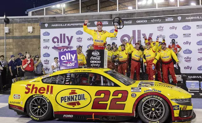Joey Logano , top,celebrates after winning a NASCAR Cup Series auto race, Sunday, June 30, 2024, in Gladeville, Tenn. (AP Photo/Wade Payne)