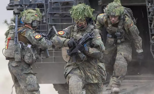 FILE - German soldiers take part in the Lithuanian-German division-level international military exercise 'Grand Quadriga 2024' at a training range in Pabrade, north of the capital Vilnius, Lithuania on Wednesday, May 29, 2024. After relying on U.S. leadership of NATO to protect them for the past 75 years, European nations must take on a larger role in funding and leading the 32-nation alliance because their interests are increasingly diverging from those of the United States. (AP Photo/Mindaugas Kulbis, File)