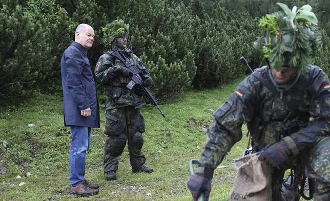 FILE - German Chancellor Olaf Scholz, left, visits the German Federal Armed Forces Bundeswehr mountain infantry brigade in Schneizlreuth, southern Germany, on July 22, 2024. With Trump's "America First" rhetoric drawing cheers from fervent supporters, the future of the North Atlantic Treaty Organization is once again on the agenda. (Alexandra Beier/Pool Photo via AP, File)