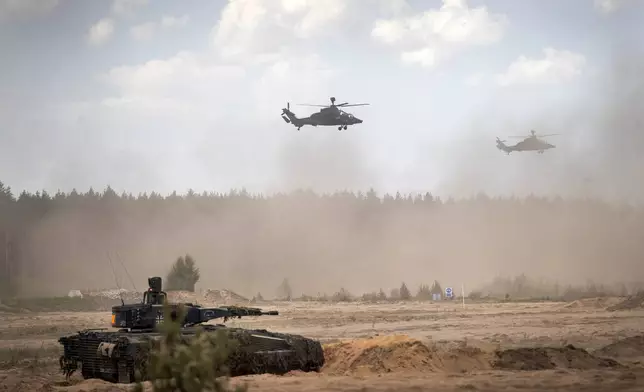 FILE - Eurocopters Tiger of the German Army take part in the Lithuanian-German division-level international military exercise 'Grand Quadriga 2024' at a training range in Pabrade, north of the capital Vilnius, Lithuania on May 29, 2024. NATO's military structure is headed by the Supreme Allied Commander Europe, who is also the commander-in-chief of American forces in Europe. (AP Photo/Mindaugas Kulbis, File)