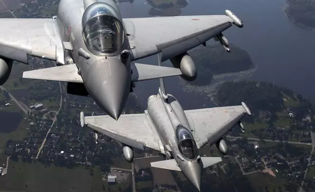 FILE - Italian Air Force Eurofighter Typhoon military fighter jets participate in NATO's Baltic Air Policing Mission operate in Lithuanian airspace, on Sept.12, 2023. NATO grew out of secret talks among U.S. officials after World War II about how to supply military equipment to Western Europe and ensure a coordinated response to any attack by the Soviet Union. (AP Photo/Mindaugas Kulbis, File)