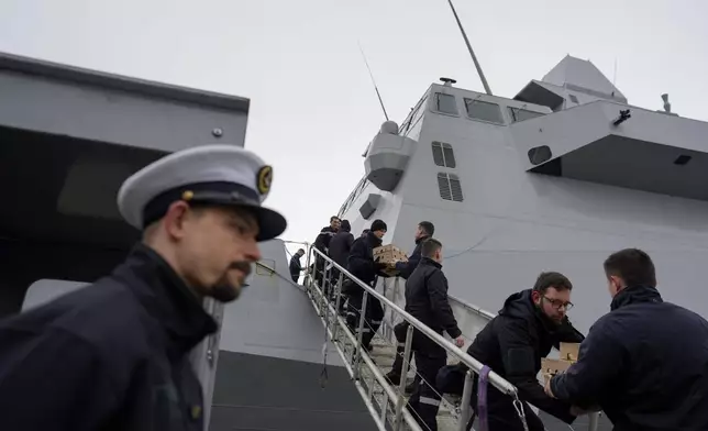 FILE - French sailors form a chain to load supplies on board of the French navy frigate Normandie during a port call in a Norwegian fjord, north of the Arctic circle, as part of exercises codenamed Steadfast Defender, Friday March 8, 2024. With the war in its third year, NATO now has 500,000 military personnel on high readiness to counter an attack, whether it be on land, at sea, by air or in cyberspace. Allies are almost continuously conducting military exercises. One of them this year, Steadfast Defender, involved around 90,000 troops operating across Europe. (AP Photo/Thibault Camus, File)