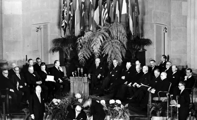 FILE - Belgium's Premier and Foreign Minister Paul-Henri Spaak, seated center, tests a new pen before signing the North Atlantic Pact in Washington, DC, April 4, 1949, flanked by Belgium's Ambassador to the U.S., Baron Silvercruys, left, and John W. Foley of the U.S. State Department. Seated behind, from left, are Britain's Ernest Bevin, Norway's Halvard Lange, Luxembourg's Joseph Bech, Iceland's Bjarni Benediktsson, Denmark's Gustav Rasmussen, U.S. President Harry S. Truman, U.S. Secretary of State Dean Acheson; Canada's Lester Pearson, France's Robert Schuman, Italy's Count Carlo Spforza, Holland's Dirk Stikker and Portugal's Jose Caeiro Da Matta. Founded in 1949, the North Atlantic Treaty Organization was formed by 12 nations to counter the threat to European security posed by the Soviet Union during the Cold War. (AP Photo, File)