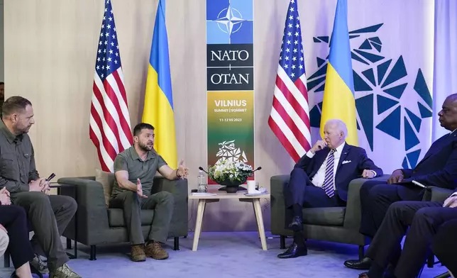 FILE - President Joe Biden listens as Ukraine's President Volodymyr Zelenskyy speaks during a meeting on the sidelines of the NATO summit in Vilnius, Lithuania, Wednesday, July 12, 2023. U.S. President Joe Biden and his NATO counterparts are meeting in Washington this week to mark the 75th anniversary of the world's biggest security organization just as Russia presses its advantage on the battlefield in Ukraine. (AP Photo/Susan Walsh, File)