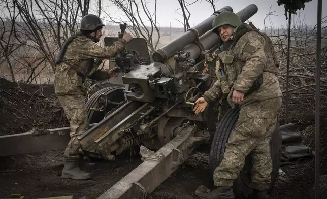 FILE - Ukrainian soldiers of the 71st Jaeger Brigade fire a M101 howitzer towards Russian positions at the frontline, near Avdiivka, Donetsk region, Ukraine, Friday, March 22, 2024. Much of what NATO can do for Ukraine, and indeed for global security, is misunderstood. Often in the public mind, the alliance is thought of as the sum of all U.S. relations with its European partners, from imposing sanctions and other costs on Russia to sending arms and ammunition. But as an organization its brief is limited to the defense by military means of its 32 member countries and a commitment to help keep the peace in Europe and North America. (AP Photo/Efrem Lukatsky, File)