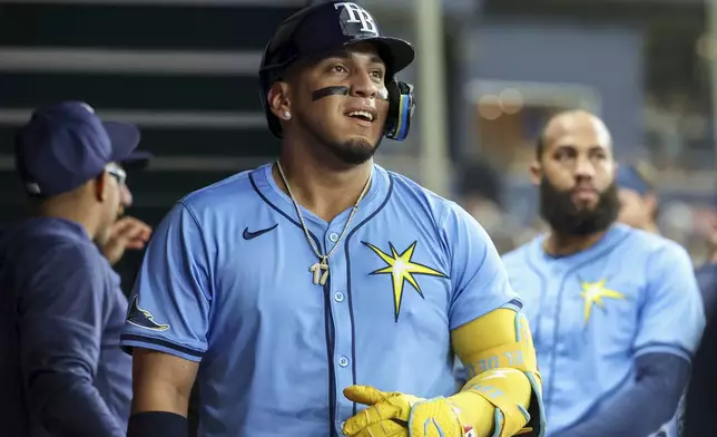 Tampa Bay Rays' Isaac Paredes, center, celebrates after his home run against the Washington Nationals during the second inning of a baseball game Sunday, June 30, 2024, in St. Petersburg, Fla. (AP Photo/Mike Carlson)