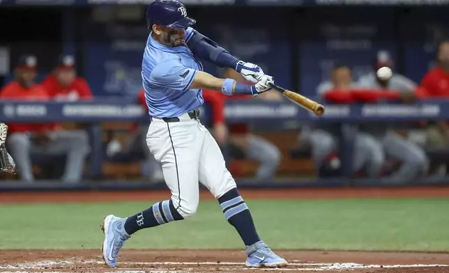 Tampa Bay Rays' Jose Caballero hits a two-run home run against the Washington Nationals during the second inning of a baseball game Sunday, June 30, 2024, in St. Petersburg, Fla. (AP Photo/Mike Carlson)