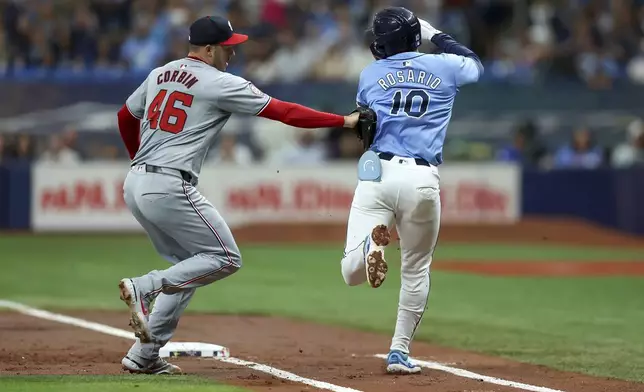 Washington Nationals starting pitcher Patrick Corbin, left, tags out Tampa Bay Rays' Amed Rosario on a ground ball during the first inning of a baseball game, Sunday, June 30, 2024, in St. Petersburg, Fla. (AP Photo/Mike Carlson)