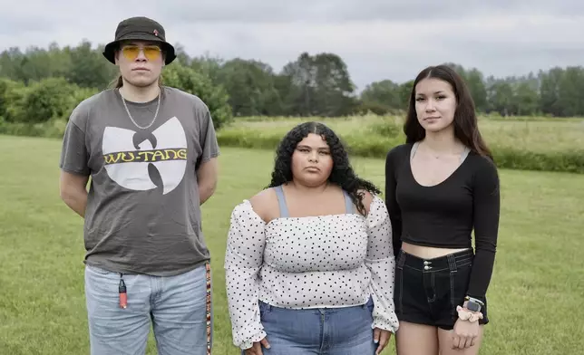 Jakob Wilson, Isabella Stensrud-Eubanks, and Kaiya Wilson pose for a photo on Tuesday, July 2, 2024, in Hinckley, Minn. (AP Photo/Mark Vancleave)