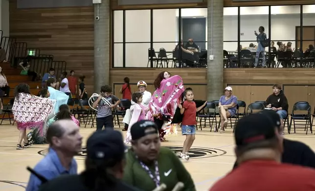 Community members dance to the drum during an open drum and dance night at Minneapolis American Indian Center on Wednesday, July 10. 2024, in Minneapolis, Minn. (AP Photo/Mark Vancleave)