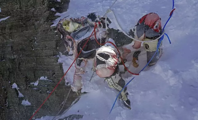 This image provided by the Peak Promotion shows the body of a climber that had been frozen for years before it was removed from the Everest region, Nepal, Monday, May 13, 2024. In the seven decades since Mount Everest was first conquered, thousands of climbers have scaled the peak, and many have left behind more than just their footprints. Tons of trash and several bodies remain on the icy slopes of the world's highest mountain. (Peak Promotion via AP)