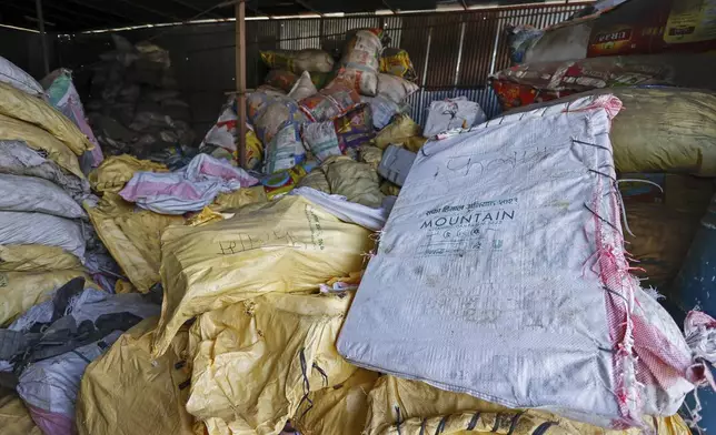 Sacks of garbage collected en route Mount Everest are piled before recycling at a facility operated by Agni Ventures, an agency that manages recyclable waste, in Kathmandu, Nepal, Monday, June 24, 2024. The highest camp on the world's tallest mountain is littered with garbage that is going to take years to clean up, according to a Sherpa who led a team that worked to clear trash and dig up dead bodies frozen for years near Mount Everest's peak. (AP Photo/Sanjog Manandhar)