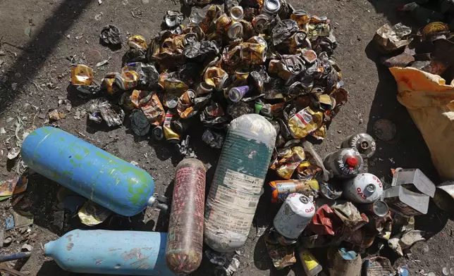 Used oxygen cylinders and beer cans collected en route Mount Everest lie at a facility operated by Agni Ventures, an agency that manages recyclable waste, in Kathmandu, Nepal, Monday, June 24, 2024. The highest camp on the world's tallest mountain is littered with garbage that is going to take years to clean up, according to a Sherpa who led a team that worked to clear trash and dig up dead bodies frozen for years near Mount Everest's peak. (AP Photo/Sanjog Manandhar)