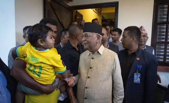 Khadga Prasad Oli, centre, the chairman of the Communist Party of Nepal leaves his residence to meet his supporters after being appointed as Prime Minister, in Kathmandu, Nepal, Sunday, July 14, 2024. The leader of the Nepal's largest communist party, Khadga Prasad Oli, was named the Himalayan nation's new prime minister on Sunday following the collapse of a previous coalition government. (AP Photo/Niranjan Shrestha)