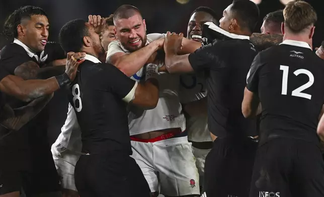 England's George Martin, center, is in a tussle with New Zealand players during their rugby union test match in Auckland, New Zealand, Saturday, July 13, 2024. (Kerry Marshall/photosport via AP)