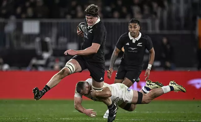 England's Ben Earl tackles New Zealand captain Scott Barrett, left, during their rugby union test match in Dunedin, New Zealand, Saturday July 6, 2024. (Andrew Cornaga/Photosport via AP)